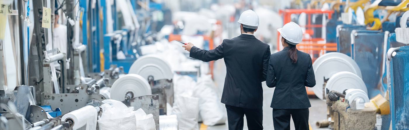 plastics manufacturing executives inspecting production line